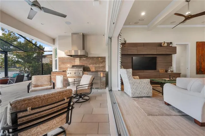 View of patio with ceiling fan, area for grilling, grilling area, and an outdoor hangout area
