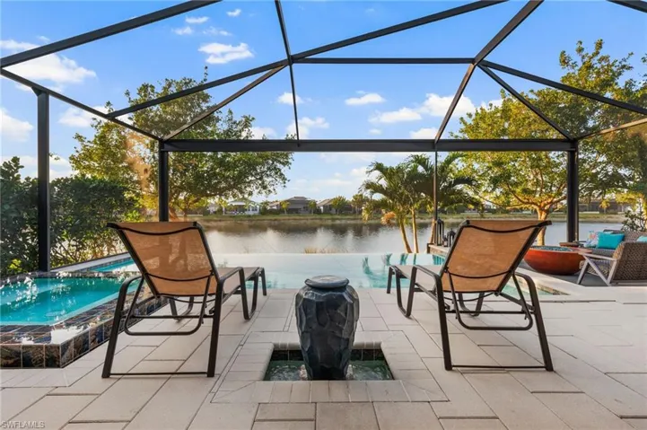 View of patio / terrace with a water view and glass enclosure