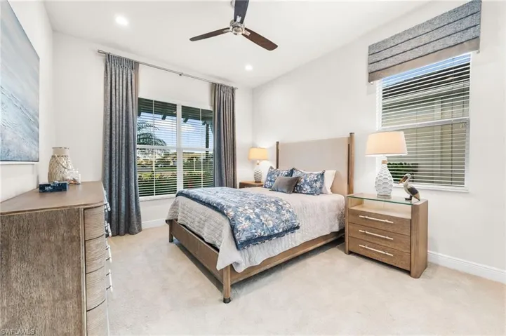Bedroom featuring ceiling fan and light carpet
