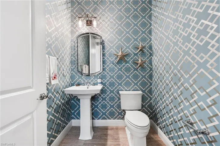 Bathroom with wood-type flooring and toilet