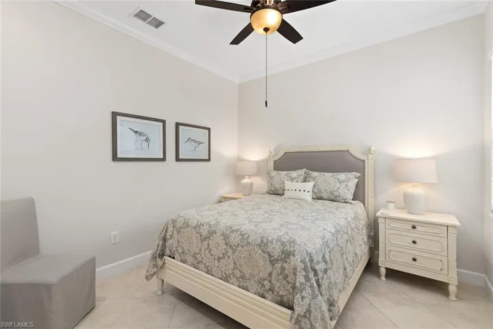 Bedroom featuring light tile patterned flooring, ceiling fan, and crown molding