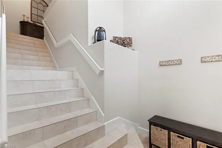 Stairway featuring tile patterned floors