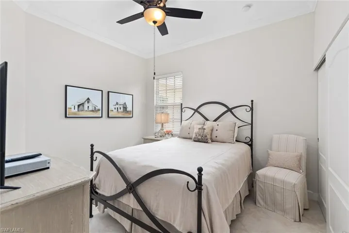 Bedroom with ornamental molding and ceiling fan