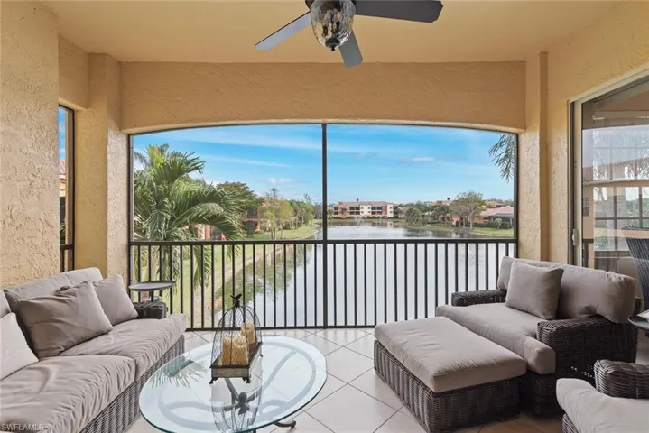 Sunroom / solarium with ceiling fan, a water view, and plenty of natural light