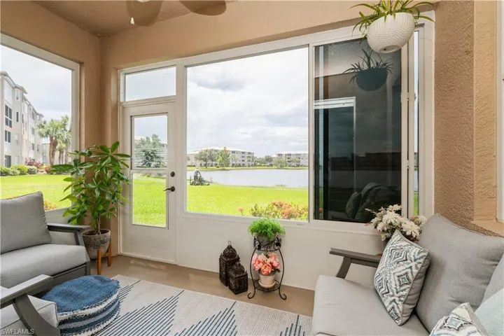 Sunroom / solarium with plenty of natural light and a water view