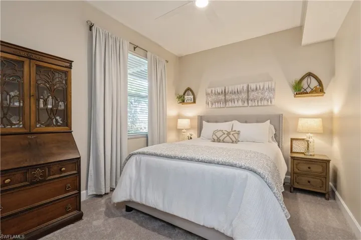 Bedroom featuring ceiling fan and light carpet