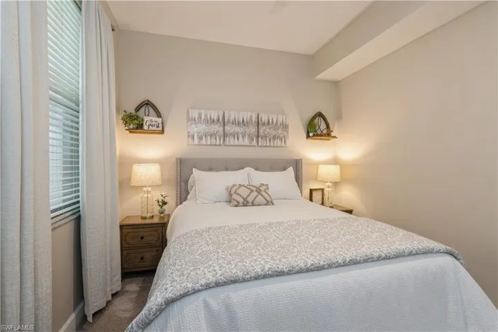 Carpeted bedroom with ceiling fan