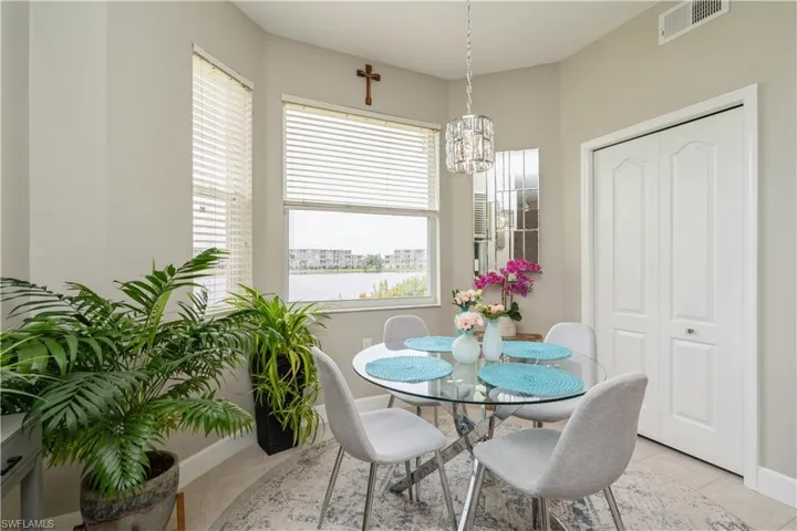Dining room with light tile patterned flooring and a chandelier