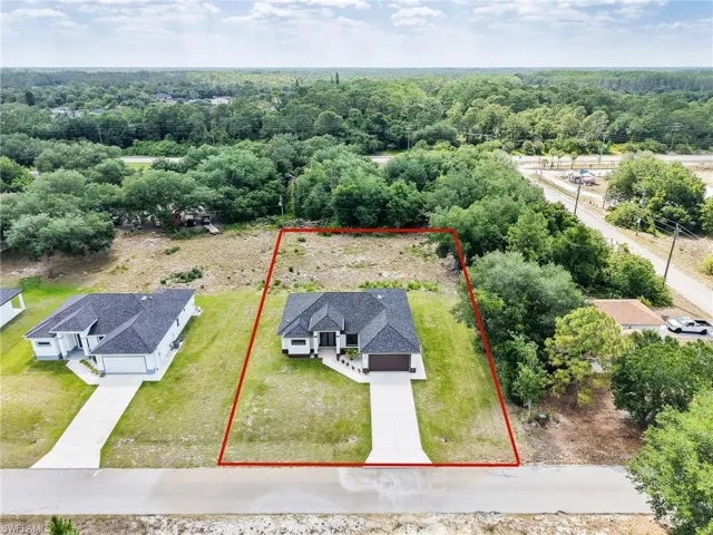 Aerial view of property and surrounding area featuring property parcel outlined