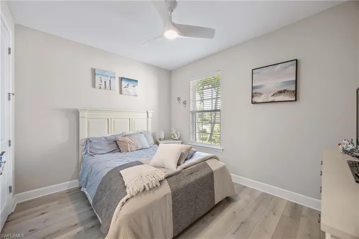 Bedroom with light wood-style floors and ceiling fan