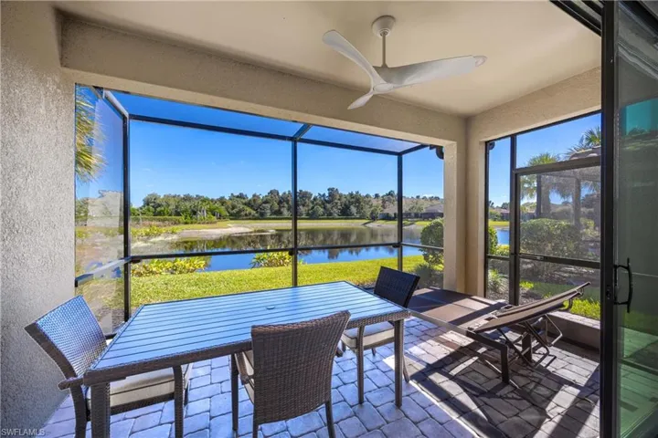 Sunroom / solarium featuring a water view