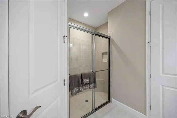 Bathroom featuring a shower stall, light tile patterned flooring, and recessed lighting