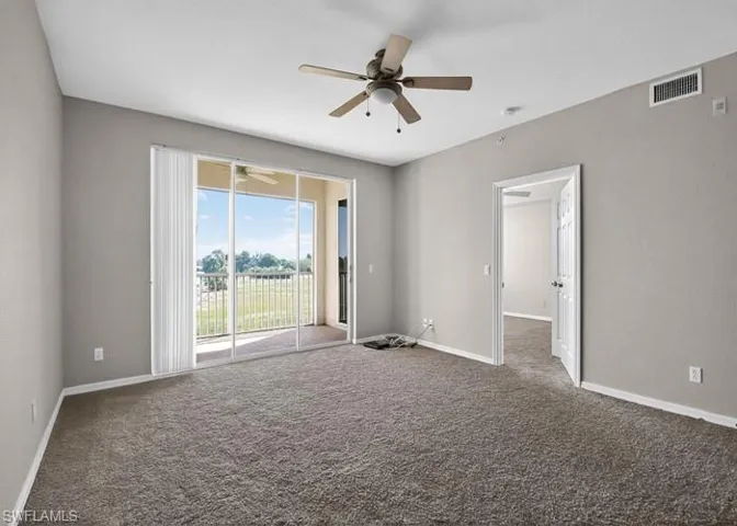 Unfurnished room with carpet flooring and baseboards