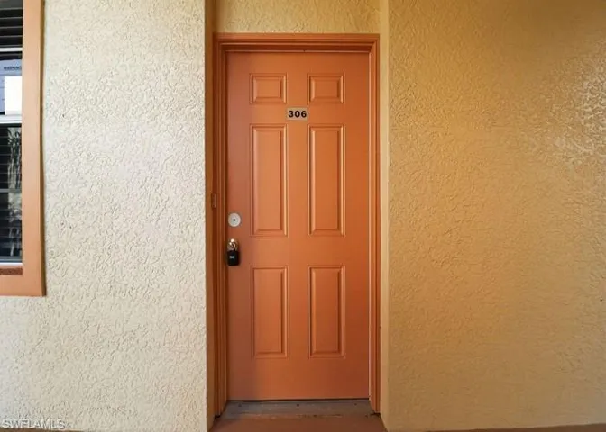 View of exterior entry with stucco siding