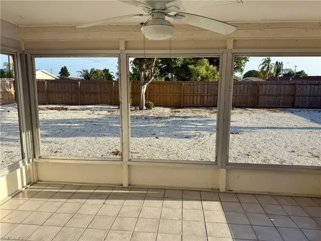 Unfurnished sunroom with ceiling fan and a healthy amount of sunlight