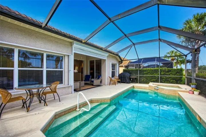 View of pool featuring a patio area and a pool with connected hot tub