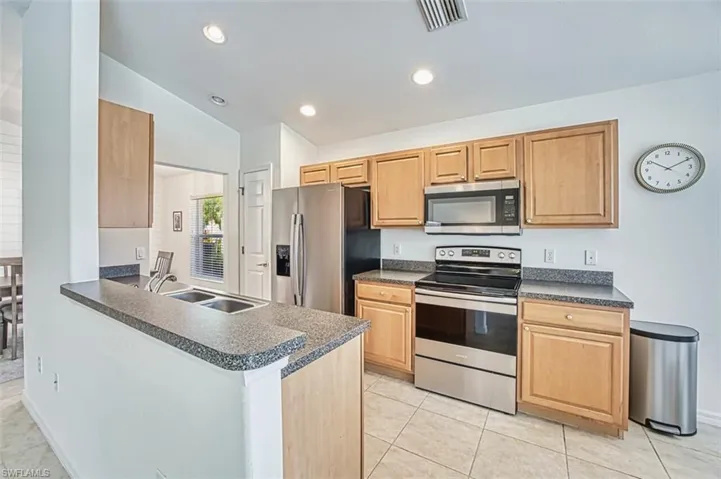 Kitchen featuring a sink, visible vents, dark countertops, and stainless steel appliances
