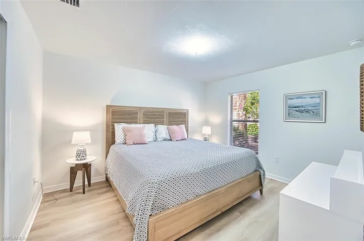Bedroom featuring light wood finished floors and baseboards