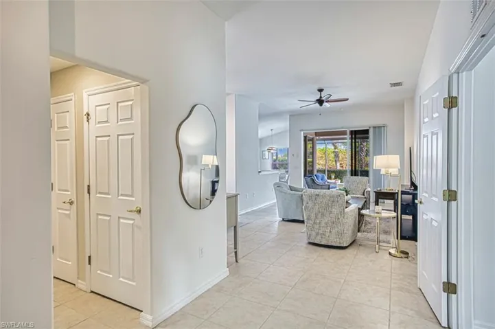 Doorway to property featuring stucco siding and a tile roof