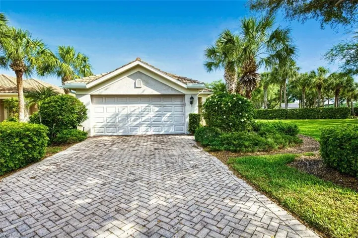 View of front of house featuring stucco siding, decorative driveway, an attached garage, and a tile roof