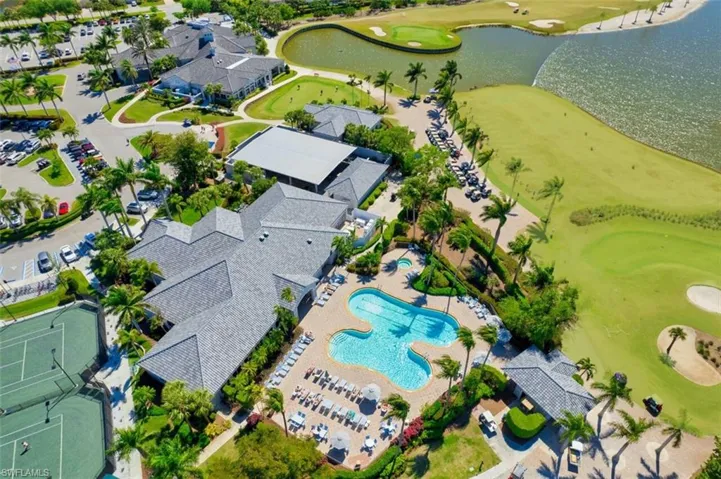 Birds eye view of property with view of golf course and a water view