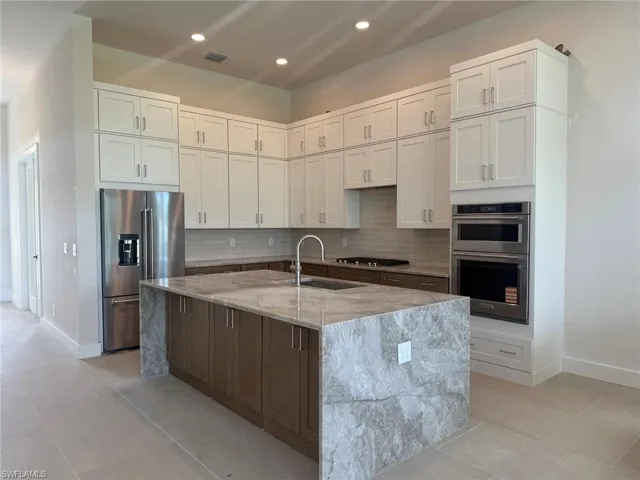 Beautiful gourmet kitchen with stunning waterfall island