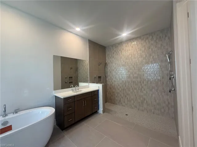 Luxe, primary bathroom with walk-in shower including dual-shower heads