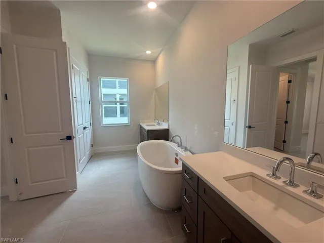 Primary bathroom with dual-sinks and free-standing soaking tub