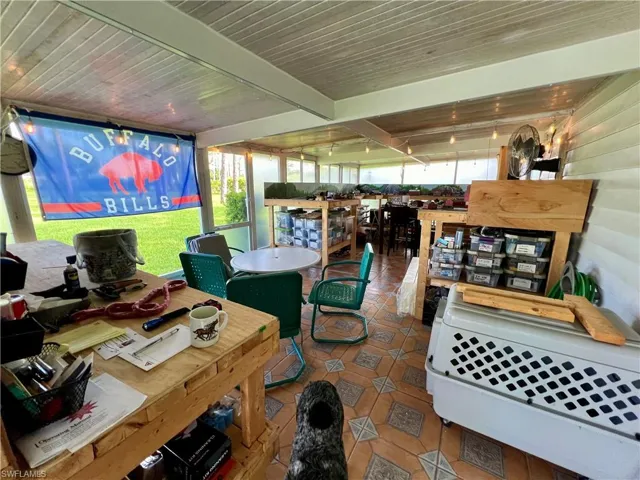 Enclosed porch with plenty of natural light, beamed ceiling, wooden ceiling, and tile patterned flooring
