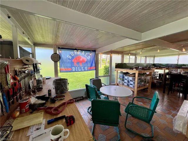 Sunroom with beamed ceiling and wooden ceiling
