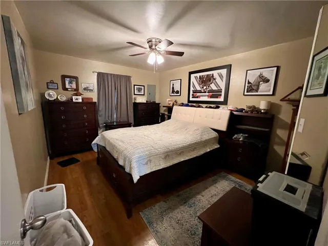 Bedroom featuring vinyl / wood-style floors and ceiling fan