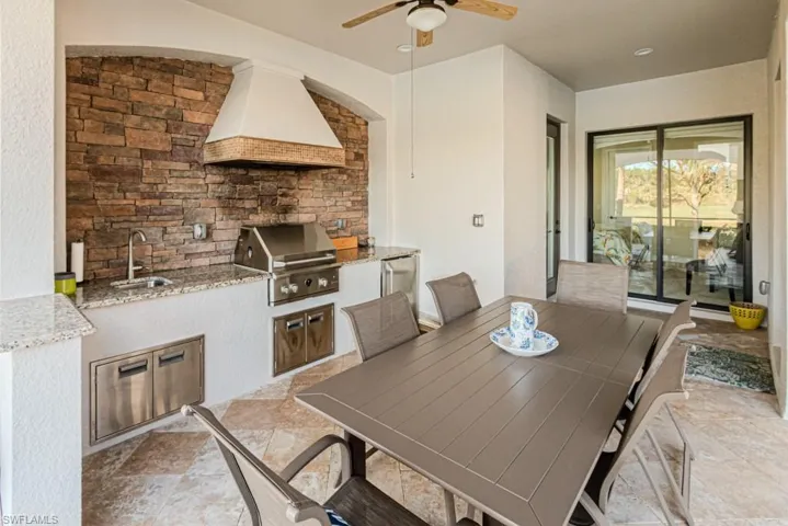View of patio / terrace featuring ceiling fan, a grill, exterior kitchen, and sink