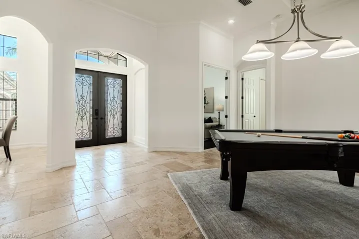 Playroom featuring french doors, a towering ceiling, crown molding, and pool table