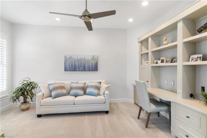 Office featuring recessed lighting, a healthy amount of sunlight, light colored carpet, and built in desk