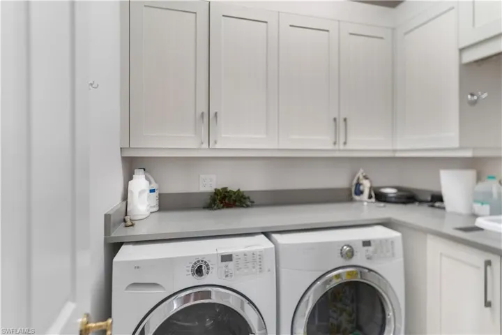 Laundry room featuring washing machine and dryer and cabinet space