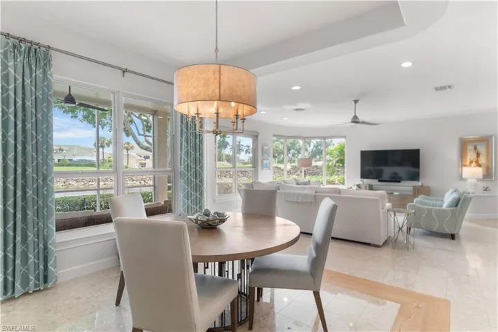 Dining area featuring recessed lighting, visible vents, baseboards, and ceiling fan with notable chandelier