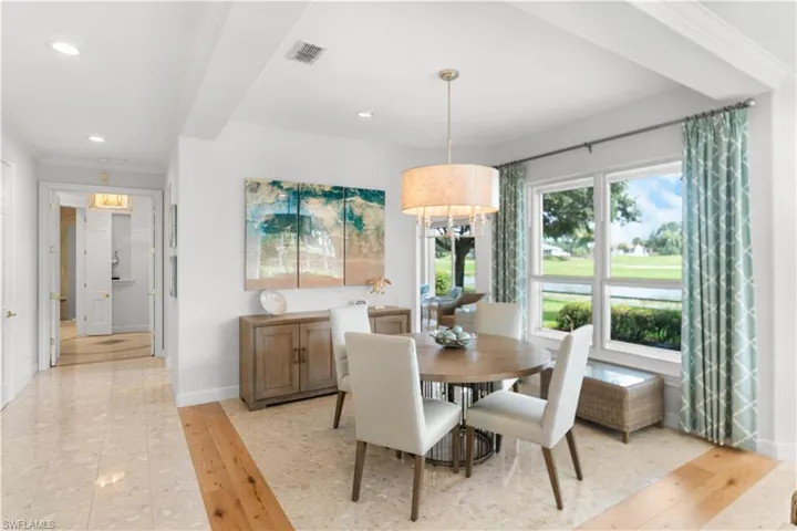 Dining area with visible vents, baseboards, ornamental molding, light wood-type flooring, and recessed lighting