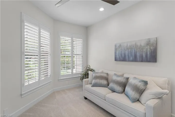 Living room with carpet floors, baseboards, a ceiling fan, and recessed lighting