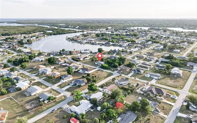 Aerial perspective showcasing a residential neighborhood with a prominent waterway