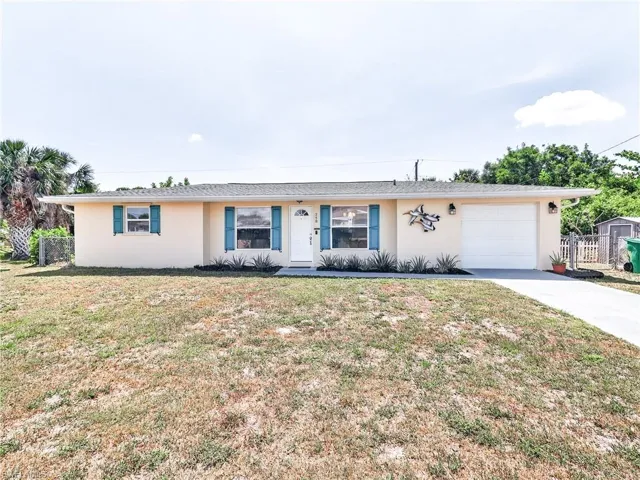 Stucco exterior with a single-car garage, white front door, and blue exterior window shutters