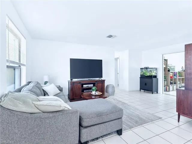 Bright living area featuring tile flooring and white walls