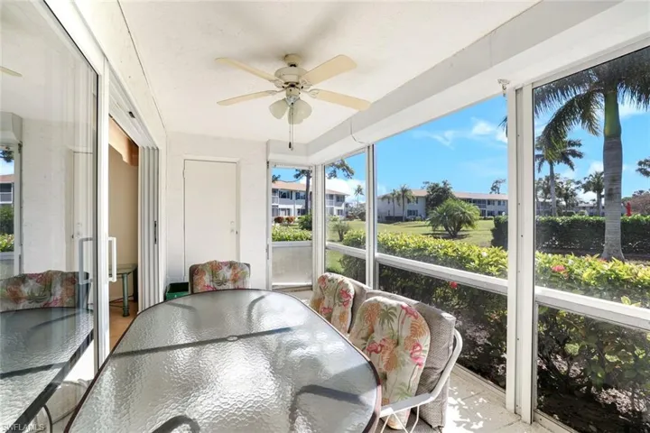 Sunroom / solarium with outdoor dining space and ceiling fan