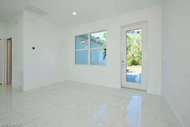 Spare room featuring light marble finish floors and recessed lighting