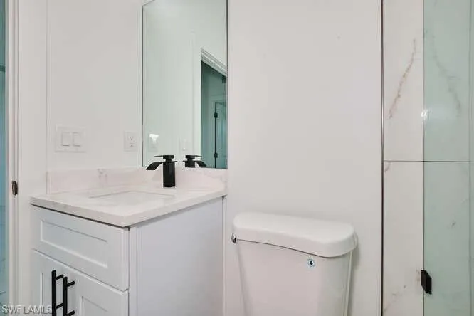 Full bath with vanity and a shower