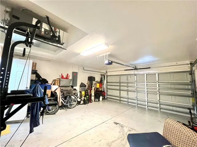 Garage with electric panel and a garage door opener