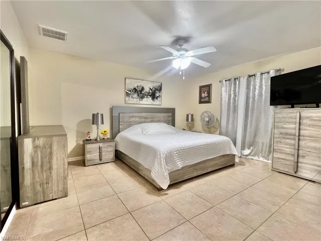 Bedroom featuring light tile patterned flooring and a ceiling fan