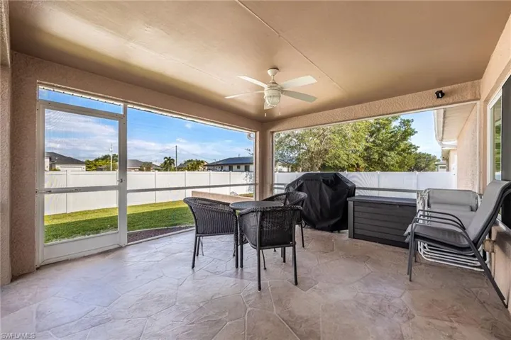 The screened patio features a ceiling fan, providing comfort for outdoor enjoyment