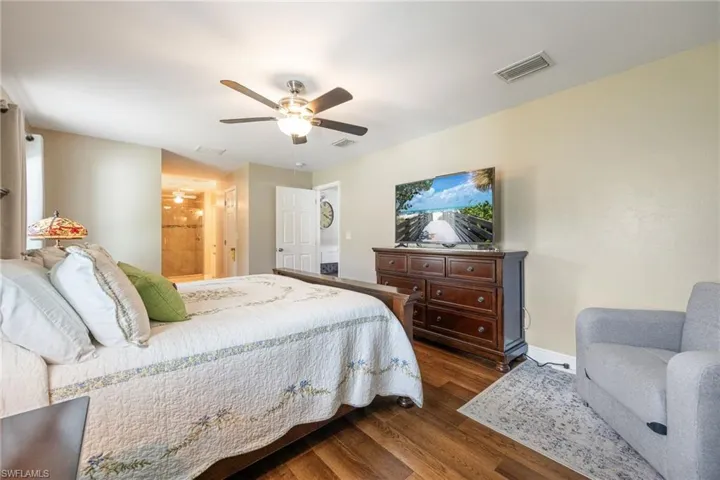 Well-appointed sleeping quarters featuring LVP wood flooring, a ceiling fan, and light-colored walls