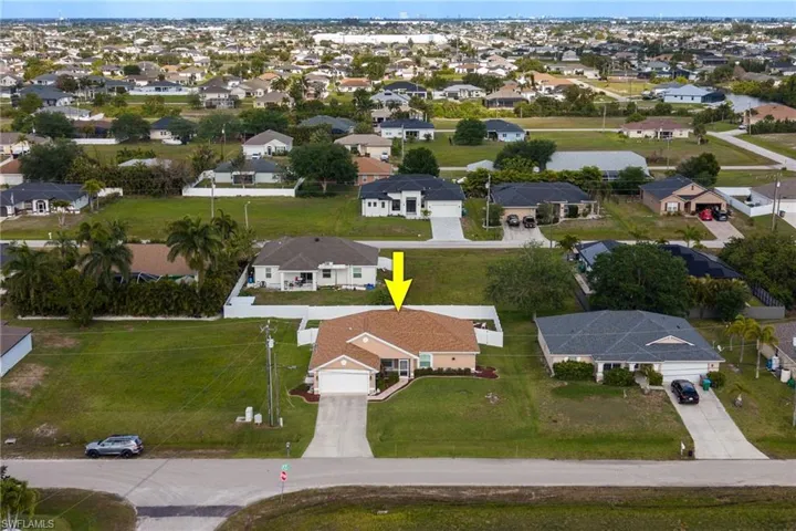 This property features a single-story residence with an attached garage and a driveway
