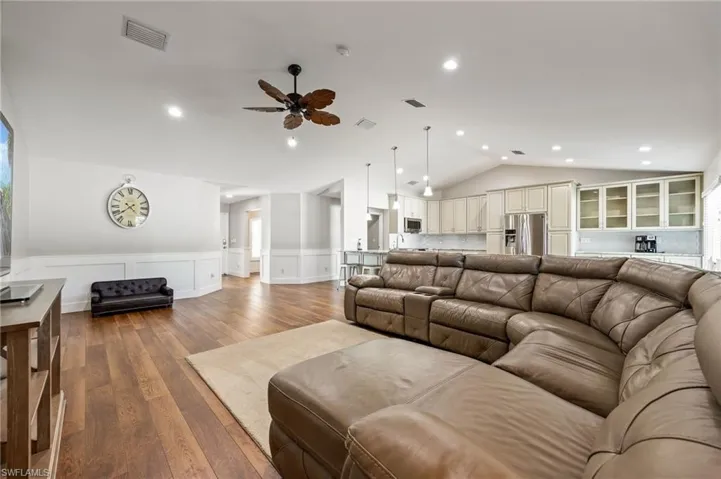 The property features an open-concept living area with LVP wood grain flooring and recessed lighting